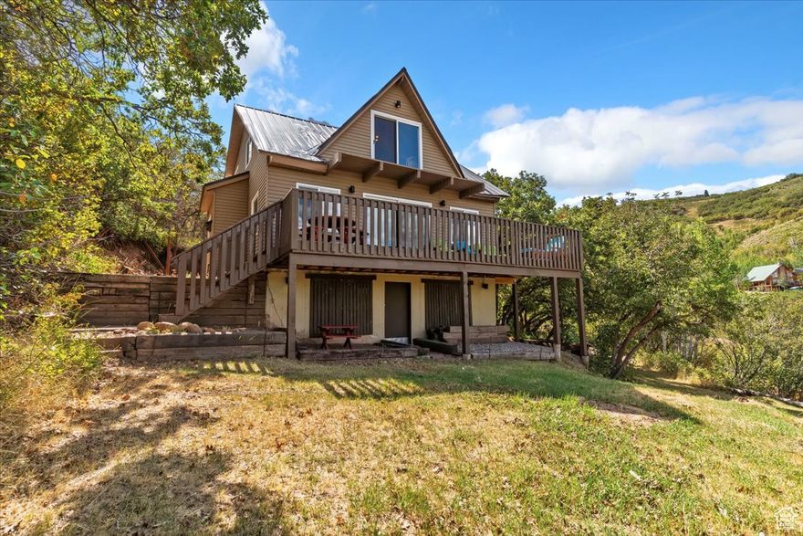 Nestled in the private, gated enclave of Causey Estates-just a scenic 20-minute drive from Huntsville, this mountain escape offers both peaceful seclusion and practical full-time living. Situated in a tight-knit community with 1,500+ acres of common ground with proximity to Causey Reservoir, Pineview Reservoir, SnowBasin, and Powder Mountain. This home blends modern comfort with a serene retreat. It includes an updated kitchen, two bathrooms, 2 private bedrooms on the main living area, a full loft, and a finished walkout basement. Beds available to sleep 20+ guests. And yes-it's equipped for all-season enjoyment. With winter access requiring tracked vehicles and private road maintenance, you're prepared for both summer retreats and winter adventures. This property is being sold fully furnished, including deck furniture, TV, foosball table, and youth kayaks. Updates: Stair lift from the basement entrance to the main floor and Trex Deck (2025)   * Not zoned for nightly rentals. Square footage figures are provided as a courtesy estimate only from county records. Buyer is advised to obtain an independent measurement.