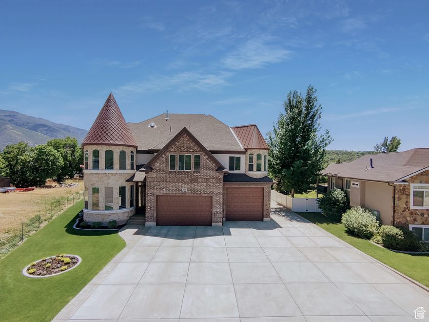 This extraordinary home is the creation of its thoughtful and inspired owners who have been designing and building this home for over 5 years. Tucked at the end of a quiet cul-de-sac in the highly desirable town of Uintah, this one-of-kind home is situated on a half of an acre and has all the space you need. If you are looking for a custom built home with a large 4-car garage with front and back garage doors and a huge 36 X 60 separate shop, then add this home to your list. Inside the home, the first floor features a grand entryway, a dramatic curved staircase and additional staircase on opposite side of the home, a formal living room, arched hallways, a large family room and custom kitchen, a guest room and bathroom. Upstairs you'll love the open space that overlooks the family room and kitchen down below. The large primary ensuite situated in the turret, has gorgeous long windows, a soaking tub and separate shower and large walk-in closet. An office, two additional lofts/dens, laundry, 3 bedrooms and 2 bathrooms are also on this level. There is plenty of room to expand in the unfinished attic space and basement. Understated elegance throughout is evident in the finishes this home offers. Embrace the chance to script your own fairytale within the walls of this home
