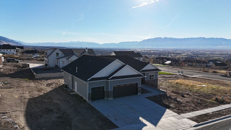 Discover unmatched elegance in this custom-built estate, perfectly positioned in one of Hyde Park's most coveted enclaves. This newly constructed 3,787 sq. ft. residence blends sophisticated design with timeless craftsmanship, offering 7 bedrooms and 4.5 baths framed by sweeping, unobstructed views of Cache Valley. Its premier location places you just moments from downtown Logan's amenities, charming local shops, and top-rated schools. The main level, spanning 1,901 sq. ft., welcomes you with soaring 9' ceilings and an effortless flow. The luxurious primary suite is a private retreat featuring a spacious walk-in closet and a spa-inspired ensuite bath. Two additional bedrooms-each with their own walk-in closets-and a finely appointed full bath elevate comfort and convenience. A beautifully designed mudroom with a half bath, built-in bench, and seamless access to the laundry room ensures everyday living remains organized and refined. At the heart of the home, a dedicated executive office off the foyer provides an inspiring setting for remote work or music instruction. The gourmet kitchen, complete with a generous pantry, is perfectly suited for both intimate meals and grand entertaining. An open-concept dining area flows to a covered deck, while the expansive family room invites gatherings large and small. Both the stove and dryers are thoughtfully plumbed for gas or electric, offering flexibility for your preferred appliances. The fully finished 1,886 sq. ft. lower level extends the home's luxury with four additional bedrooms, two well-appointed baths, a second laundry room, and an inviting family room-ideal for guests, multi-generational living, or private retreat spaces. Completing the property is a pristine 3-car finished garage, painted for a clean, polished aesthetic and pre-plumbed for a gas heater. With ample room for vehicles, storage, or a workshop, it enhances both convenience and lifestyle. Square footage figures are provided as a courtesy estimate only and were obtained from plans and developer records. Buyer is advised to obtain an independent measurement.