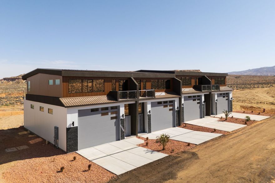 YOUR LAKE POWELL ADVENTURE HEADQUARTERS! Units are offered as a ''gray shell'' - a blank canvas ready to finish to your taste. Each features 1,637 sq. ft. of garage/storage (14x16 door, 55 ft deep) - perfect for boats, RVs, and toys - plus 1,358 sq. ft. of upper-level living space with high ceilings and a covered patio. That's nearly 3,000 sq. ft. total for your Lake Powell retreat or investment property. Nightly rental approved - imagine storing your boat and having your upper level pay for it!