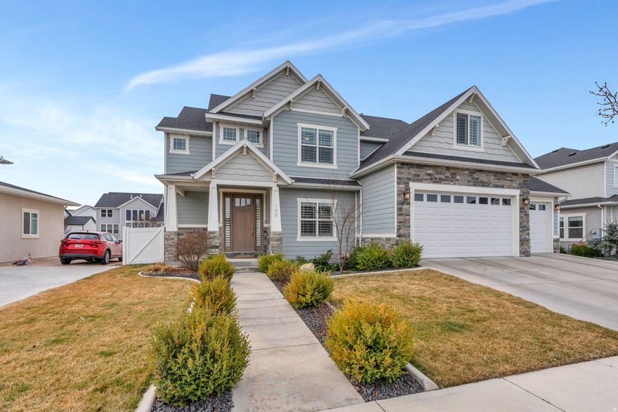 Welcome to this exceptional two-story Craftsman-style home located in one of the most convenient and desirable areas of Vineyard. Thoughtfully designed with custom finishes throughout, this home perfectly blends timeless craftsmanship with modern luxury and entertainment. The spacious layout features two full kitchens, making it ideal for entertaining, multi-generational living, or hosting gatherings with ease. The main living spaces showcase beautiful custom details, creating a warm and inviting atmosphere from the moment you step inside.  Designed for both relaxation and recreation, the home includes a private movie theater and a gym area so you can stay active without leaving home. Sports enthusiasts will love the private basketball court, offering endless opportunities for fun and exercise.  The backyard is built for memorable evenings and everyday enjoyment. Gather with family and friends around the cozy fire pit or swing, while the in-ground trampoline provides hours of fun for kids and guests alike. The outdoor space offers the perfect balance of entertainment and relaxation.  Other custom features that cannot be overlooked is the whole home generator and humidifier.  This home really has it all.  Call today to schedule your private tour.