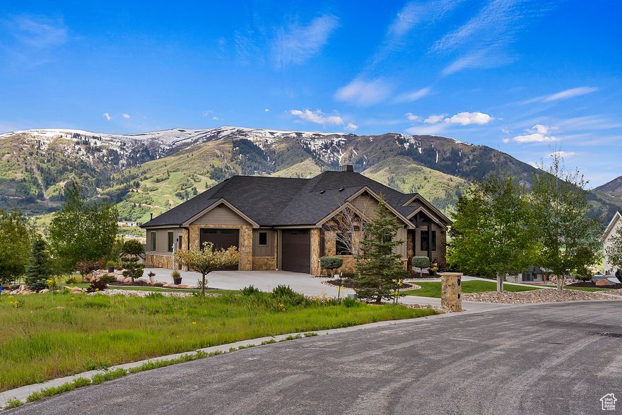 Mountain Modern Estate in Eden  A Private Outdoor Sanctuary -a custom-designed mountain modern retreat that blends architectural sophistication with the serenity of alpine living. This exceptional home is nestled on a generous lot bordered by preserved common space, offering unmatched privacy and panoramic views of Nordic Valley, North Ogden, and Ben Lomond Peak. Crafted with intention, the home features hand-hewn timbers, ambient LED lighting, and high-end finishes that elevate every space. The expansive main floor is anchored by a gourmet kitchen with custom cherrywood cabinetry, high-end appliances, and a large island perfect for both everyday living and entertaining. The adjoining dining area opens to a covered deck with gas and power hookups, generous counter space, and sweeping 180 views-an ideal setting for outdoor dining or sunrise gatherings. Designed for those who appreciate refined details and smart functionality, the home includes custom tile and concrete work throughout, a seven-zone radiant heat system, central A/C, spray foam insulation, tankless water heater, and a built-in audio system. Step outside and experience your own private resort. A custom outdoor fire pit, professionally landscaped grounds, and a private pickleball court-complete with lighting and integrated speakers-offer year-round enjoyment. With over 1,200 sq ft of heated garage space (featuring a bathroom and shop sink) plus an additional 575 sq ft in the lower-level garage, there's ample room for outdoor gear, vehicles, or hobby space-all finished with epoxy floors and painted walls. This home is a rare opportunity for the discerning buyer seeking luxury, comfort, and adventure in one of Northern Utah's most sought-after valleys. Experience Eden at its finest-schedule your private showing today.