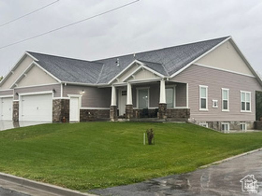 Welcome to this beautiful modern farmhouse with 4 bedrooms and 4.5 bathrooms. The open-concept layout connects the kitchen, dining, and family room-perfect for everyday living and entertaining. The primary suite includes his-and-hers closets.  Downstairs, the basement offers 3 bedrooms, 3 full bathrooms, a separate laundry room, a workout room, and a large storage room. It's plumbed for a kitchen, making it a great option for a guest suite or future rental. There's also convenient access from the 4-car garage for added privacy and flexibility.  Enjoy a spacious backyard and a covered patio-great for relaxing or hosting. An additional section of land behind the home may be bundled with buyer's offer. Reach out to agent for more info. Schedule your showing today! Square footage is provided as a courtesy estimate only; buyer to verify.
