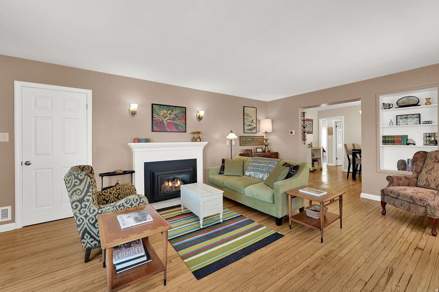 Positioned on Ogden's east bench, this home brings together comfort, updates, and convenient access to nearby trails and schools. The main level is designed for everyday living, featuring a bright layout with a large primary bedroom featuring en-suite bath with an oversized shower, and main floor laundry. The kitchen has been updated with newer cabinetry, granite countertops, and stainless steel appliances, offering a clean and functional workspace. The second main floor bathroom has also been refreshed with updated cabinetry and finishes.  Original hardwood floors add warmth and character, while a gas log fireplace anchors the main living area. Major systems-including the furnace, A/C, and water heater-were replaced in 2020, along with newer vinyl windows for added efficiency and long-term peace of mind. The yard is shaded by mature trees and offers room to expand or fully fence by enclosing the driveways. With two driveways and a one-car garage, there is ample parking and storage, all in a location close to schools and outdoor recreation.