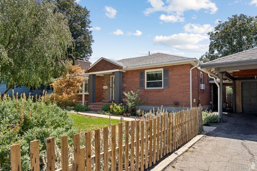 Wonderful brick rambler with a two-bedroom apartment in a desirable East Millcreek location on a large .32 acre lot. Home boasts five bedrooms and three baths including a primary suite with its own en suite bath. Lovely kitchen featuring white cabinets, quartz countertops, tile backsplash and stainless-steel appliances. Spacious living room with crown molding, a gas fireplace and adjacent dining area that opens to the backyard. The yard is large and fully fenced with a brick paved patio, vegetable garden with raised garden beds, fruit trees and would be perfect for BBQs or urban farming. Basement apartment has separate front and rear entrances and features a living room with fireplace, two bedrooms and a bath plus its own parking area making it well suited for use as a rental to help pay your mortgage. Updated flooring and new carpet throughout. Two-car garage with attached shop area plus a two-car carport. Conveniently located just minutes to shopping, restaurants, freeways, schools, parks, Millcreek Common and more! Property is zoned "RM"(Residential Mixed) with Millcreek City. Easy to show, call for your appointment today. Buyer to verify all.