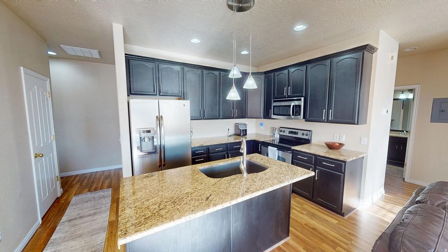 This well maintained 2-bedroom, 2-bathroom residence offers modern finishes within the established Towns at Hunter neighborhood of West Valley City- this property provides updated interior systems and access to community amenities.   Interior Upgrades & Key Features Premium Kitchen: Finished with durable granite countertops, and stainless steel appliances.  Modern Bathrooms: Both full bathrooms feature upgraded granite vanities.  Inclusions: Move-in ready with the refrigerator, washer, and dryer all included in the sale.  Major System Updates: new furnace (2024) and central AC (2020) for reduced utility costs and long-term reliability.  Garage: Attached 1-car garage providing secure parking and additional storage.   Community Amenities (HOA) The community offers a maintenance-free lifestyle with professional management including:  Community Clubhouse for private events.  Swimming Pool .  On-site Playground.   Location & Proximity Data Situated near the intersection of major transit and entertainment hubs, this location is a primary choice for West Valley City residents:  Retail & Dining: Minutes from Valley Fair Mall, a regional destination featuring 870,000+ sq. ft. of retail, 22+ restaurants, and a 15-screen IMAX theater.  Entertainment: quick access to the Maverik Center, USANA Amphitheatre, and the Utah Cultural Celebration Center.  Parks & Recreation: Walking distance or short drive to Centennial Park (sports courts/walking trails) and the Ridge Golf Club.  Commuter Access: Strategically located near the Mountain View Corridor and I-215, providing a 15-20 minute commute to Downtown Salt Lake City and the SLC International Airport.