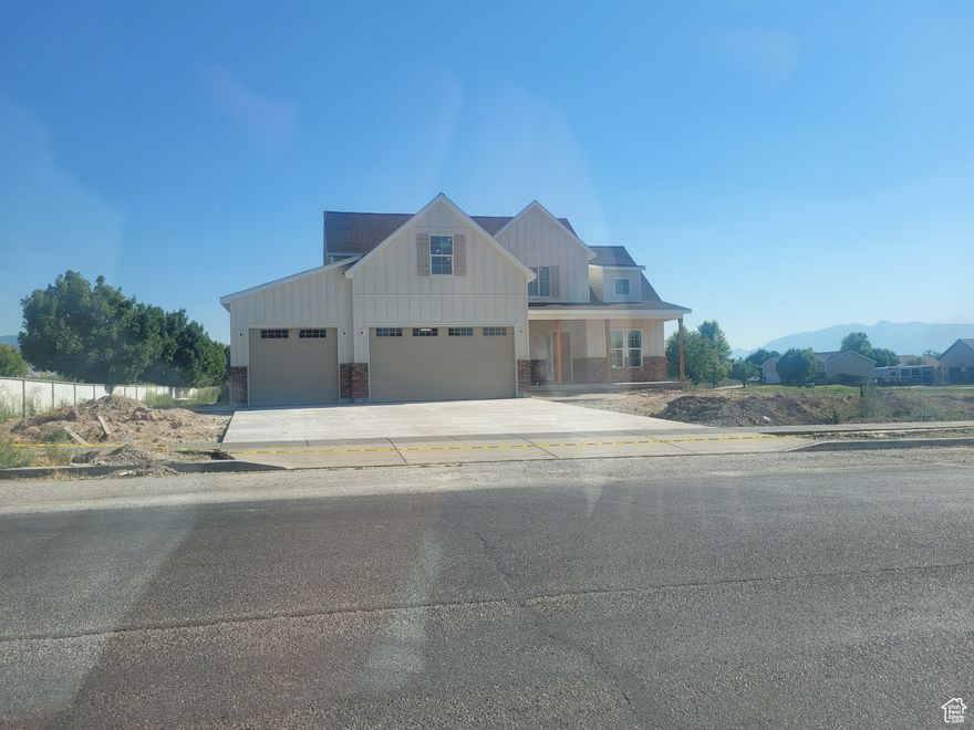 This beautifully designed new construction home sits on a flat, fully usable lot. Thoughtfully built for comfort, style, and functionality. Highlights Include: Extra-deep 3-car garage with 12-ft ceilings, rear storage, 220V for EV. Massive wrap-around covered back porch with window wells, hot tub power, and private walk-out from the master bedroom. Vaulted main living with 10-ft ceilings, 8-ft doors, 7" baseboards, and knotty alder beams matching the front door. Gourmet kitchen with 36" hood, walk-in pantry (with side door), an open floor plan with shiplapped fireplace. Master suite with double vanity, soaker tub, walk-in shower, closet, and porch access. Bonus room, flex room with nook and shiplap, 9-ft upstairs ceilings, and oversized tub. Basement includes two bedrooms, an office, two storage rooms, built-in TV space, shelving, and 9-ft ceilings. Tankless water heater, recirculation loop, insulated lines, water softener, 2 furnaces & AC units for efficiency. Built-ins in mud/laundry room, pocket doors, Google Fiber-ready with smurf tubing, and full irrigation rights. This home was meticulously designed with lifestyle and future-proofing in mind-from power-ready garage and hot tub setup to flexible spaces that grow with you. Every detail has been considered for timeless style and effortless living. Don't miss your chance to own this one-of-a-kind property with unmatched craftsmanship.
