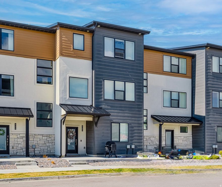 This gorgeous townhome is ideally located just steps from the clubhouse, pool, and top-tier community amenities. Enjoy breathtaking mountain views and a wealth of high-end upgrades, including an extended kitchen island, sleek quartz backsplash, ceiling-height cabinetry, and premium flooring and carpet. All appliances included as a bonus! The grand primary suite features a luxurious bath with a Euro glass shower, dual sinks, and designer lighting-even the 2-car attached garage is upgraded with recessed lighting! Plus, with soundproofed walls, you can enjoy ultimate privacy and peace. Conveniently located just minutes from the Frontrunner station and freeway, this home is a rare find that combines luxury, comfort, and accessibility. Don't miss this incredible opportunity!