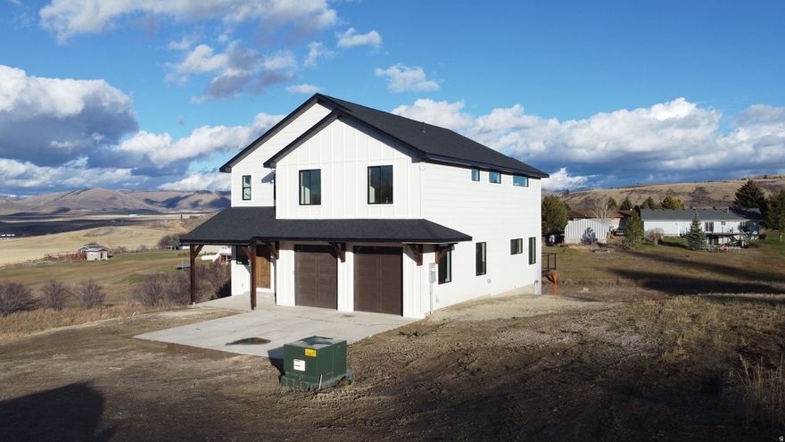 Beautiful New Construction in Bailey Creek  Modern Comfort with Mountain Views!!  Welcome to this stunning brand new home nestled in the Bailey Creek community just outside Soda Springs. This thoughtfully designed 3-bedroom, 2-bath two-story home combines timeless craftsmanship with modern finishes and incredible views!  Step inside to find real hardwood oak floors, clear alder cabinetry, and quartz countertops that bring warmth and elegance to every space. The handcrafted hardwood staircase and professionally built metal handrails showcase quality and craftsmanship.   The home features an open-concept main level filled with panoramic views and abundant natural light year-round. Truly, a space that must be witnessed in person that captures the warmth and comfort of home. Upstairs, you'll find all three bedrooms, including a large master suite and a convenient laundry room. Vaulted ceilings throughout the entire upper level! The basement includes a walkout to a beautiful backyard and is designed with potential in mind-ready for an additional bedroom and bathroom to be finished to your liking.  You'll love the oversized, heated two-car garage with 9-foot-tall doors, providing plenty of room for trucks, toys, and workspace. The exterior is clad in durable LP SmartSide and finished with premium Sherwin-Williams Latitude paint, ensuring long-lasting protection and style.  Disclaimer: The last interior finishes are being installed. Contact the listing agent for a showing today! Drew (208) 221-9401