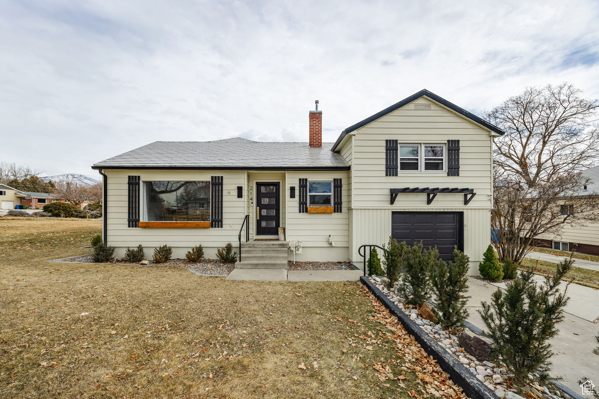 A stunningly distinctive house with a blend of old-world charm and modern design in a well-established Smithfield neighborhood. This seven-bedroom, four-bathroom home is situated on a great lot (with additional land available) and features a spacious garden with plenty of outdoor play space, mature maple and ash trees, and a leveled firepit area. There are cherry, peach, and apple trees in the garden. The main floor has a master suite (with attached laundry room) and an extra bedroom/bathroom, as well as a mudroom, kitchen, dining area, and living room in an open floor design ideal for entertaining. New cabinets, updated lighting, and new hardware have all been added to the kitchen. Two huge bedrooms with ample closet space and storage are located upstairs. Great neighborhood and mountain views. The fully finished basement has a living area, two full bathrooms, a second laundry room and three bedrooms. This home also features secondary water shares, updated appliances, HVAC system and a lifetime metal shingle roof. An automated sprinkler system uses secondary water to irrigate all of the landscaping. Several updates were done in 2020, including a back sliding door to provide access to a new Trex deck, the replacement of the basement's outdated electrical sub panel, the installation of GFCI outlets in the kitchen and all of the bathrooms, and the installation of new outlets and lighting in the heated/cooled garage. Make an appointment for a viewing right now! Homebuyer gets first right to purchase the adjacent corner lot.