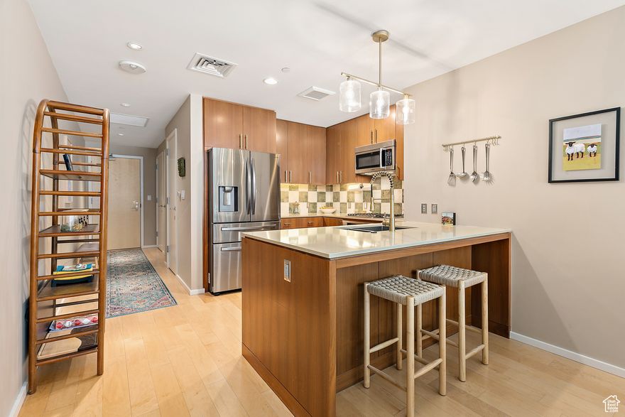 Welcome to a unique green oasis in the midst of downtown City Creek! This delightful condo includes a large 375 sq. ft. private terrace complete with flower gardens, including automatic irrigation. Great for entertaining! The terrace is situated next to an expansive, newly planted, green space, which is maintained by the HOA. The bright and airy interior, with its efficient, open floor plan boasts exquisite fixtures and includes all indoor and outdoor furnishings (primarily Crate and Barrel brand), ensuring a truly turnkey, no-hassle transition. The newly painted condo highlights the Samsung Frame TV, which displays your favorite artwork and photos, and complements the fireplace and contemporary decor. The Regent also features first-class amenities, including a new indoor pool with outdoor lounging deck, spa, two cold plunge pools, locker rooms, as well as an exercise room and multiple lounge and public areas. The truly upscale Regent at City Creek affords unparalleled access to grocery, world-class shopping, restaurants, cafes, and sporting events. The convenient light rail provides rapid service to the international airport and more distant destinations. This condo is the perfect blend of sophisticated downtown living as well the enjoyment of your private gardens and adjoining green space... truly a serene, urban retreat.   ** Buyer to verify all info provided **