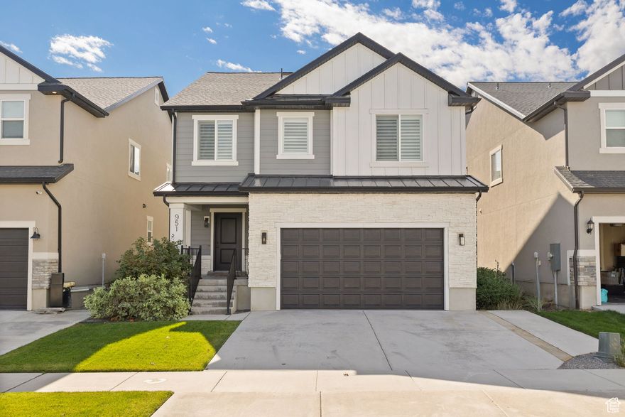 This is not your standard Bluffdale two-story. Built in 2019, this home feels brand new in all the right ways. From the flooring to the fixtures, every inch of this home has been renewed with intention by Canyon Craft. Their signature craftsmanship carries through every space.  Step through the front door into a spacious entryway that immediately sets the tone for the rest of the home. The layout flows naturally into a bright open-concept kitchen and living space that feels warm and inviting. The kitchen has been completely refreshed with modern backsplash, upgraded fixtures and designer curated paint. It features quartz countertops, a large overhang island, gas range and stainless steel appliances.   The LVP flooring continues through the main floor into the living room where a gas log fireplace with a shiplap and stone surround creates a perfect focal point. Oversized windows bring in soft natural light, complemented by maintenance free, hardwired roller shades (no recharging battery packs, yay!). The entire main floor is designed for everyday living with a sense of comfort, style and privacy.  Upstairs, the oversized primary suite feels like a retreat. The ensuite bathroom features dual sinks, a large walk-in closet, and an elegant partial euro-glass shower. Two additional bedrooms, a full bathroom, and a large laundry room complete the upper level, giving plenty of space and function. The second story feature custom shutter window coverings in all the windows.  The fully finished basement adds even more versatility. A large second living room makes a great theater or playroom. The fourth bedroom, complete with French doors, works perfectly as a home office or guest space. A third full bathroom ties the basement together and makes it ideal for long-term guests or a growing household.  Outside, the backyard is private and peaceful. Mature trees line the property, creating a natural sense of separation. The patio with fire pit adds an inviting outdoor living space that works in every season. The two-car garage is spotless, finished with epoxy flooring and space for two vehicles and extra storage.  This home blends modern luxury with thoughtful detail in a way that feels effortless. From the craftsmanship to the finishes, every inch has been cared for. It's the kind of home that feels custom the moment you walk through the door. Staging has been done by Stage 7 Design and all the furniture is available for sale.    Square footage figures are provided as a courtesy estimate only and were obtained from County Records.  Buyer is advised to obtain an independent measurement.