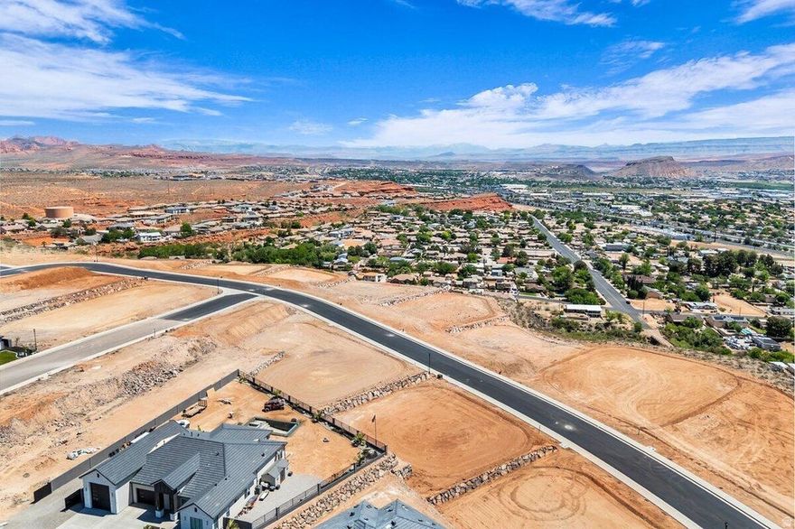 Interior view lot with exceptional views overlooking the city, mountains, Pine Valley, red rock mesas, Sand Hollow, and even Zion National Park! Best suited for a walkout floor plan, this lot is located in the final phase of Grand Heights, the highest elevated subdivision in St. George proper, nearly 500 feet higher than the rest of town, including Stone Cliff and Foremaster, offering unmatched views. Enjoy quick access to downtown, hiking and biking trails, and off-road adventures, plus you're just 15 minutes from two major fishing reservoirs and over half a dozen top-rated golf courses. With BLM land bordering the subdivision, you can ride bikes and ATVs straight from your doorstep. Numerous oversized lots are available with convenient highway access. Bring your own builder! Buyer is responsible for water impact fees. All construction requires prior review and approval by the architectural control committee. Buyer to verify all information, deemed reliable, however buyer to verify all info including utilities & ACC information if applicable.