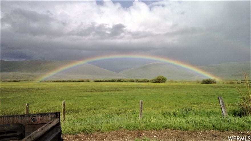 Located on the eastern slope of the majestic Bear River Mountain Range near Nounan Valley, Elkhorn Ranch offers a turnkey ranching operation with a rich history of breeding champion rodeo bucking broncs and horses while cultivating habitat for trophy mule deer to thrive year-round.  Hunting and fishing enthusiasts are drawn to this property for the abundance of wildlife.  Large herds of mule deer are seen nightly and there is a good herd of resident elk on the property.  160" to 175" trophy mule deer bucks are taken every year and it is not uncommon to harvest a 200" trophy buck.  Approximately 500 acres are farmed; currently in hay, 3-way (barley, wheat and oats) and sainfoin which is an attractant and feed for mule deer and elk.  The deer are also drawn to the bitter brush which is abundant on the ranch in the higher elevations.  The owner is striving to improve the soil biology and enhance the pasture grasses with rotational grazing management, using the herd effect.  He works diligently to develop the land in a manner that has increased productivity and self-sustainability and is willing to advise the new owners on the nuances of the land and how to sustain the ranch to continue to provide habitat that will support trophy mule deer to live on it year-round.  The property consists of two separate tracts of land, approximately half a mile apart and connected by a network of two-track roads. This enables access to the full extent of the acreage, making it ripe for development.  Mature water rights support a well-developed, gravity fed, pressurized sprinkler and flood irrigation network, covering 150 acres of meadow grass in the south tract.  Stauffer Creek winds through the northeast side of the south tract, providing more than half a mile of waterfront and creating prime spawning grounds for Bonneville Cutthroat trout.  Idaho Fish and Game are managing a diversion point on this property for irrigation and fish that will commence in the fall of 2022 to improve and enhance the fishery in Stauffer Creek.   A well-maintained farmhouse and ranch infrastructure are in the north tract with year-round access and power off Stauffer Canyon Road.  Expansive acreage of pasture ground and farmland, combined with high elevation steep sloping hillside, provide views as far as the eye can see, yet, a feeling of seclusion with the surrounding mountain landscape.    The south tract has two year-round, flowing, spring-fed ponds fed by Fern Creek and springs.  The pond, by the meadows, is 20 feet deep and has been stocked with trout in the past.  In 2016, the ranch was host to the Mountain Man Rendezvous, where 375 campsites / teepees inhabited the south tract around the pond and unfinished cabin site.  Prior to the Rendezvous, the spring water was tested and deemed drinkable.  The majestic rolling hills of Stauffer Canyon provide an outdoor recreation enthusiast's paradise with Cache National Forrest close by and access to miles of dirt roads and trails to explore backpacking, mountain biking, cruising in ATVs, and big game and upland game hunting.  Winter access to much of Stauffer Canyon requires a snow machine and opens the door to a winter wonderland to explore snowmobiling, cross country skiing, and snowshoeing.  A canyon property like this one is a rare find.  Contact the listing agents today to schedule a tour.    Gravity fed, pressurized sprinkler and flood irrigation network  Fern Creek and Stauffer Creek water rights dating back to the 1880's  Water rights to several developed springs are filed in owner's name, up to date & ready for adjudication.  Water shares to cover 150 acres   2 year-round flowing, spring-fed ponds fed by Fern Creek & springs, one of which is 20 feet deep  Mineral rights & water rights convey with the sale of the property  Bonneville Cutthroat prime spawning grounds  160"-175" mule deer bucks are taken every year   Large herds of mule deer are seen nightly  Good herd of resident elk   Wire fenced perimeter with