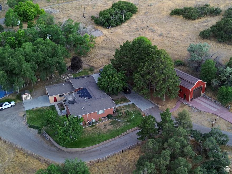 Rare chance to own nearly 12 acres in Salt Lake County with Water Rights and Water Shares & Animal Rights. Perfectly positioned between Saratoga Springs, Riverton & Lehi. Experience quiet rural living with the convenience of being minutes from all the ammenities of modern life. This expansive estate features trees, a seasonal stream, large barn, 4 car garage, basketball court, and a 7 bedroom home with 4 bathrooms and a walk out basement providing abundant space for family, guests, and multi-generational living. Step outside and experience the property's true magic of fenced pastures and multiple outdoor spaces for recreation and relaxation. Designed for self-sufficiency, this estate blends independence and security with modern comfort. Whether you envision a working ranch, hobby farm, or serene getaway, the possibilities are endless. The water for the home comes from a private spring.