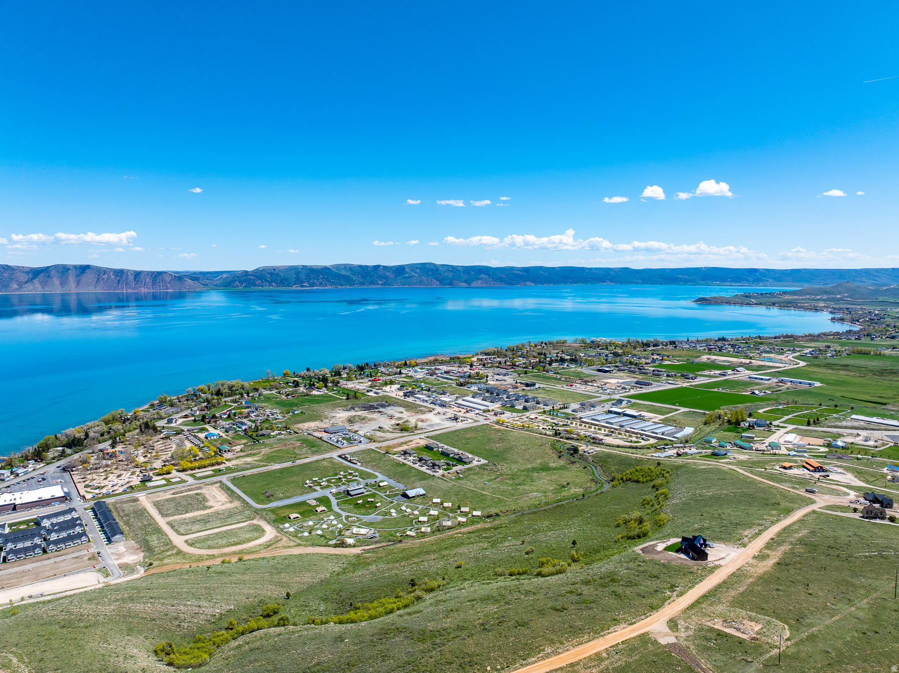 Expansive aerial perspective showcasing a large body of water bordered by distant mountains