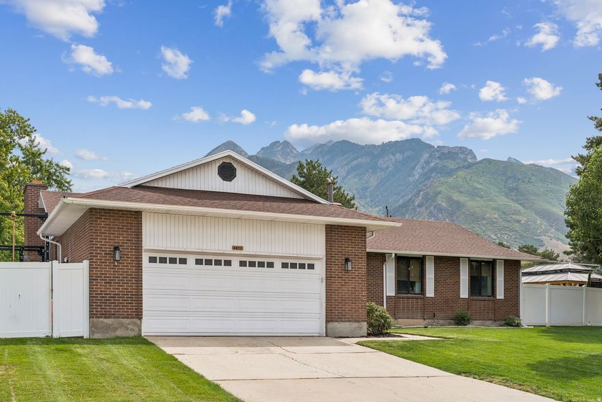 Don't miss your chance to own a home in one of Cottonwood Heights' most sought-after neighborhoods up on Butler Hill! Perfectly positioned just 2 minutes from the base of Big Cottonwood Canyon, this beautifully remodeled brick rambler sits on the corner of a quiet cul-de-sac with sidewalks, mountain views, and a strong sense of community. Over the past three years, this home has undergone a complete transformation. Top-to-bottom upgrades include a new furnace and AC, all new windows in the basement, a new 200-AMP exterior electrical panel, Senawave Fiber Internet, fresh paint throughout, a radon mitigation system, new carpet, tile, LVP flooring, trimwork, custom railings, quartz countertops, updated bathrooms, and lighting fixtures. Step into the open-concept main living area where the chef's kitchen features high-end custom solid wood cabinetry, a stone backsplash, convection gas double wall ovens, gas range, deep stainless steel sink, stainless steel fridge, and a brand-new KitchenAid dishwasher-all surrounded by sleek quartz countertops.  Upstairs, you'll find three bedrooms offering flexibility for a home office or guest space. The primary includes a luxurious ensuite bathroom with a euro-glass shower and a rainfall showerhead. Main floor laundry adds everyday convenience. Downstairs, enjoy a large living room, dining area, mini bar with sink, and a flex space with a custom rock feature wall-ideal for hobbies or a second office. A second wood-burning fireplace with an oversized hearth creates a cozy retreat after a day on the slopes. Two additional bedrooms and a full bathroom with an oversized vanity offer room to grow. One of the downstairs bedrooms is spacious enough to accommodate a full home gym. Outdoor living is a dream with a new covered pergola, wiring for a hot tub, an area for couches and a firepit, and a dedicated entertainment area that has been used with a projector screen for movie nights under the stars. Privacy panels and planter boxes enhance the intimacy of the space while preserving breathtaking mountain views. Storage is abundant with two basement storage rooms, a two-car garage, and an exterior concrete slab. Commuting is a breeze with quick access to I-215 via the 6200 S exit. It takes around 20 minutes to get to Solitude ski resort, downtown SLC, and the SLC International Airport. Located in the highly rated Canyons School District, this home offers both luxury and practicality. Hundreds of thousands in upgrades have turned this 1980s rambler into a modern, move-in-ready haven-perfect for entertaining, relaxing, and enjoying everything Cottonwood Heights has to offer.
