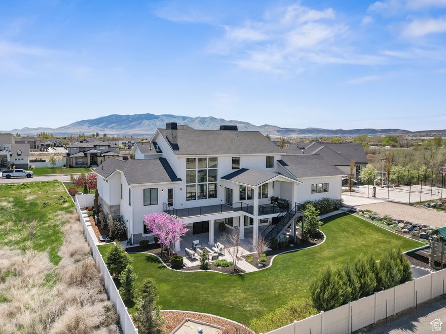 *CHECK OUT THE VIDEO TOUR*. Step into luxury with this stunning, one-of-a-kind home that truly has it all. Designed for both comfort and entertaining, this property features vaulted ceilings, custom cabinetry throughout, and a dream kitchen outfitted with top-of-the-line appliances and a spacious butler's pantry that houses a built in ice maker. Multiple dedicated office spaces allow working from home or homework to be effortless, while each level boasts its own spacious living area. The thoughtfully finished basement offers the flexibility of a high-end entertaining space or could be utilized as separate living quarters with its full kitchen and private access. Enjoy your own own spaces currently set up as a home gym and personal golf simulator, perfect for year-round fitness and fun. A separate mudroom entrance adds convenience, and there's abundant parking for any personal or recreational vehicles in the 1,472 garage. Outside, relax on the sizable covered Trex deck and gather around the built-in firepit. The horse property behind the home offers obostructed views of the valley along with privacy.  According to the builder, the water table is low enough for a pool. This home blends luxury and functionality in every detail.  Buyer to verify all.