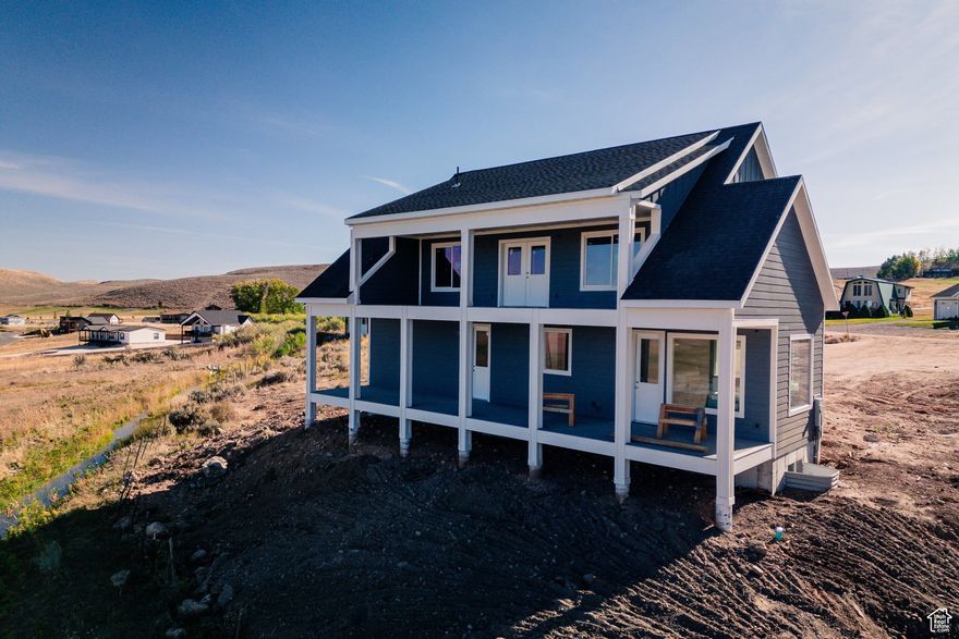 Special Offer: Close on this home by December 31, and the builder will contribute $10,000 toward your closing costs-a little holiday bonus to start your Bear Lake story off right. From the moment you step inside, this 4-bedroom, 3.5-bath Bear Lake farmhouse draws you in with its easy charm and thoughtful design. Natural light fills the open floor plan, where the spacious kitchen and great room set the stage for laughter, good food, and unhurried conversations. Step out onto the wraparound deck to take in the lake and mountain views, or head downstairs to the private theater room for movie nights and game days. Whether you're here for weekends or staying year-round, this home makes it easy to slow down, reconnect, and soak up the Bear Lake lifestyle.