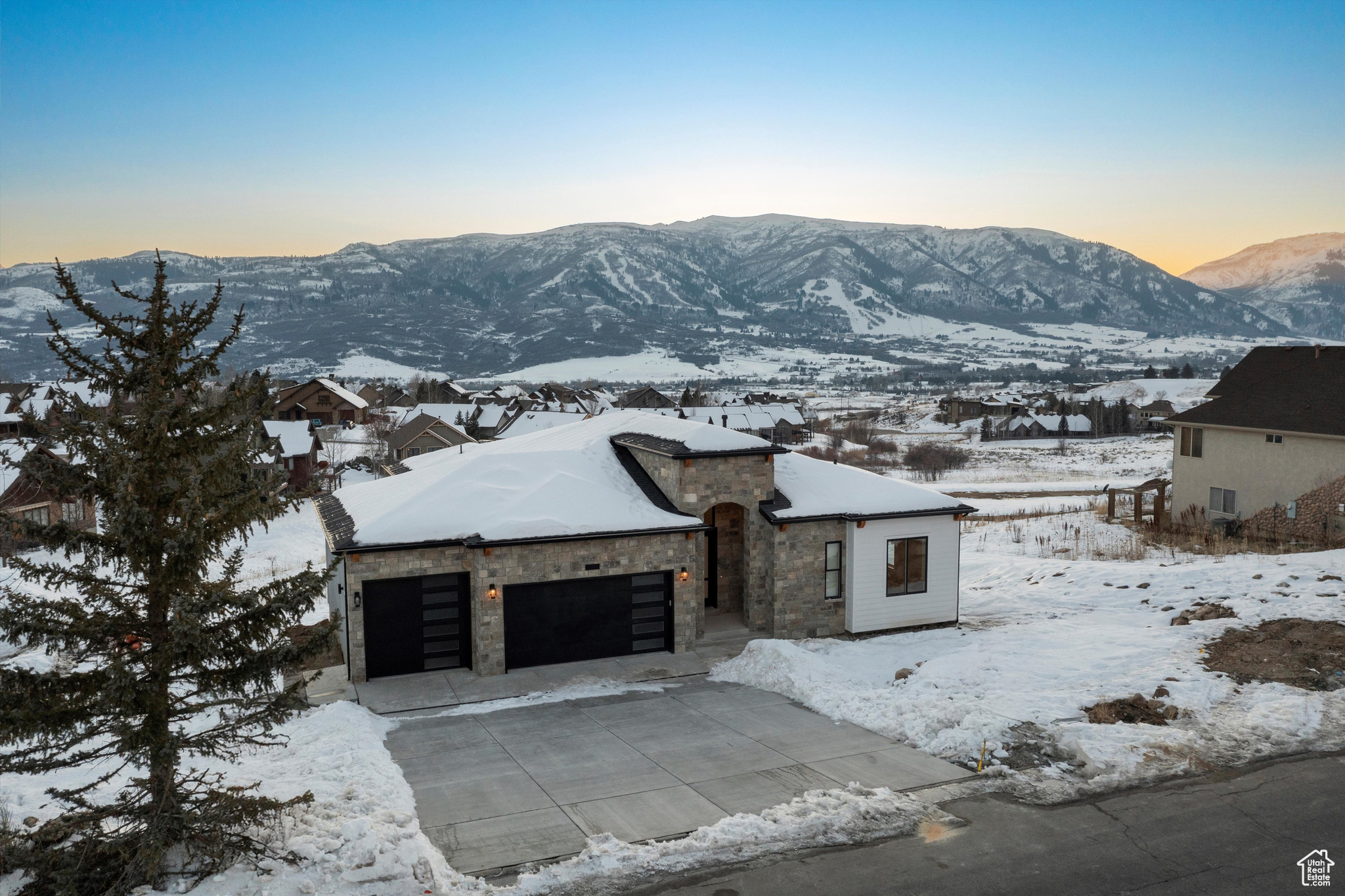 Discover unparalleled luxury and some of the most impressive views in the valley with this custom-built Ranch home in Eden, Utah. This one-of-a-kind property boasts commanding views of the Wasatch Mountains, Ben Lomond Peak, Mount Ogden Peak, the Nordic Valley Ski Resort, and Snowbasin ski resort from the moment you walk through the front door.  With 14-foot ceilings on the main level and 12-foot ceilings in the massive walk out basement, this open layout and views make this home an extremely unique and impressive property.  This home sets a new benchmark for features that every homeowner would ever want or need.  Living in a breathtaking mountain setting you will enjoy features such as massive bedrooms with impressive mountain views, a private study or flex room, a huge open kitchen and great room with views, views and more views!  The huge, extra deep garage with a Wake boat bay, 9x9 door and 30 feet deep is a rare find. As you step inside, you are greeted by engineered highly durable and waterproof flooring that sweeps through most of the residence. The chef's kitchen is a culinary masterpiece, outfitted with a huge walk-in pantry and premium GE Caf appliances, including a 48" refrigerator, gas cooktop, double ovens and a drawer microwave. This space extends out onto an incredible covered outdoor living/entertaining area complete with an outdoor fireplace.  The master suite is a haven of luxury, featuring a designer bathroom, an expansive walk-in closet, private access to the laundry and a private balcony that presents serene views-ideal for unwinding in privacy and comfort. The lower-level impresses with a massive entertainment area complete with more views, a wet bar, two bedrooms, an impressive bath, laundry, cold storage, extra storage, a living room with a separate entrance and an amazing soundproof theater room. This entire space offers great flexibility for extended stay guests or family.  The walkout basement area also features a huge covered patio, ready and wired for a future hot tub. This property offers an array of additional luxurious features too numerous to list here, making it a truly exceptional home for those seeking luxury and exclusivity in one of Utah's most desirable locations. This home sits in a recreational paradise, offering direct access to Ogden Valley's extensive trail network, the Wolf Creek Resort golf course, water sports at Pineview Reservoir, and world-class skiing at Snow Basin, Powder Mountain and Nordic Valley. Square footage figures are provided as a courtesy estimate only and were obtained from building plans. Buyer is advised to obtain an independent measurement.