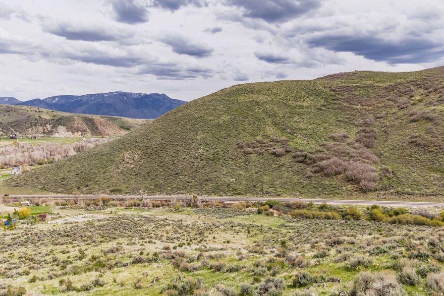 This 19.9-acre homesite offers unmatched privacy and exclusivity within a five-lot community. The property showcases spectacular down-valley views of Peoa, the Uinta Mountains, the Weber River, and features approximately 300 feet of seasonal creek frontage. The lot is uniquely equipped for a parcel of its size, featuring year-round paved road access, power at the lot line, dedicated water share for ponds & landscaping . Residential acreage zoning, ideal for a dream single-family residence, outbuildings, or equestrian facilities The location provides a perfect balance of mountain sanctuary and accessibility, situated just 8 miles east of downtown Park City and within 16 miles of major ski resorts including Deer Valley's East Village and Canyons Village. Additionally, Rockport and Jordanelle State Parks are nearby, offering endless opportunities for fishing, boating, and hiking.