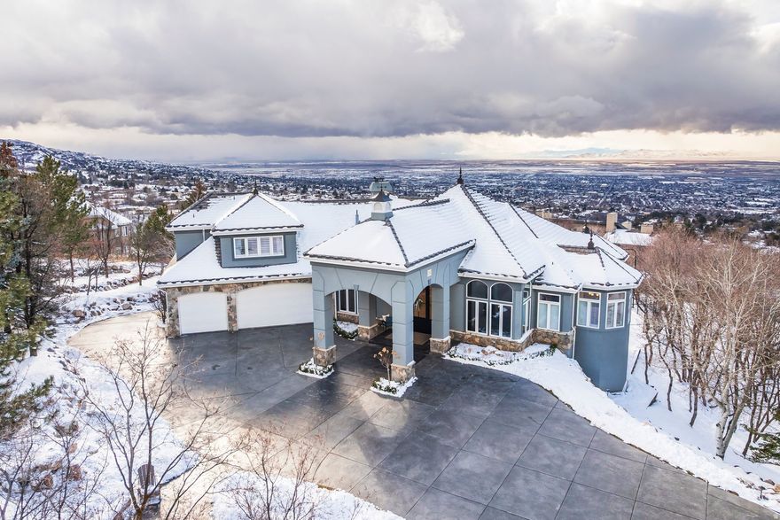 Experience an extraordinary blend of luxury, recreation, and breathtaking scenery in this remarkable hillside estate. Situated on 1.29 acres, the property captures sweeping valley and mountain views that can be enjoyed from multiple expansive patios and decks, creating an exceptional setting for both quiet relaxation and elegant entertaining. One of the home's most distinctive features is the impressive indoor swimming pool area, thoughtfully designed with its own adjoining kitchen-perfect for hosting gatherings and enjoying year-round recreation in comfort and style. The residence has undergone an extensive remodel within the past 12 months, enhancing both its aesthetic appeal and functionality throughout. The thoughtfully designed walk-out basement provides seamless access to the beautifully landscaped grounds, where you'll find a private pickleball court, a putting green, and a tranquil waterfall feature that enhances the outdoor ambiance. Inside, a grand and memorable entry welcomes guests and sets the tone for the refined living spaces that follow. At the heart of the home, the recently remodeled kitchen showcases modern finishes and elevated functionality, creating an inviting space for both daily living and entertaining. Completing the property is a spacious three-car garage and a collection of exceptional indoor and outdoor amenities. With its stunning views and resort-style features, this estate presents a rare opportunity for elevated living and recreation.