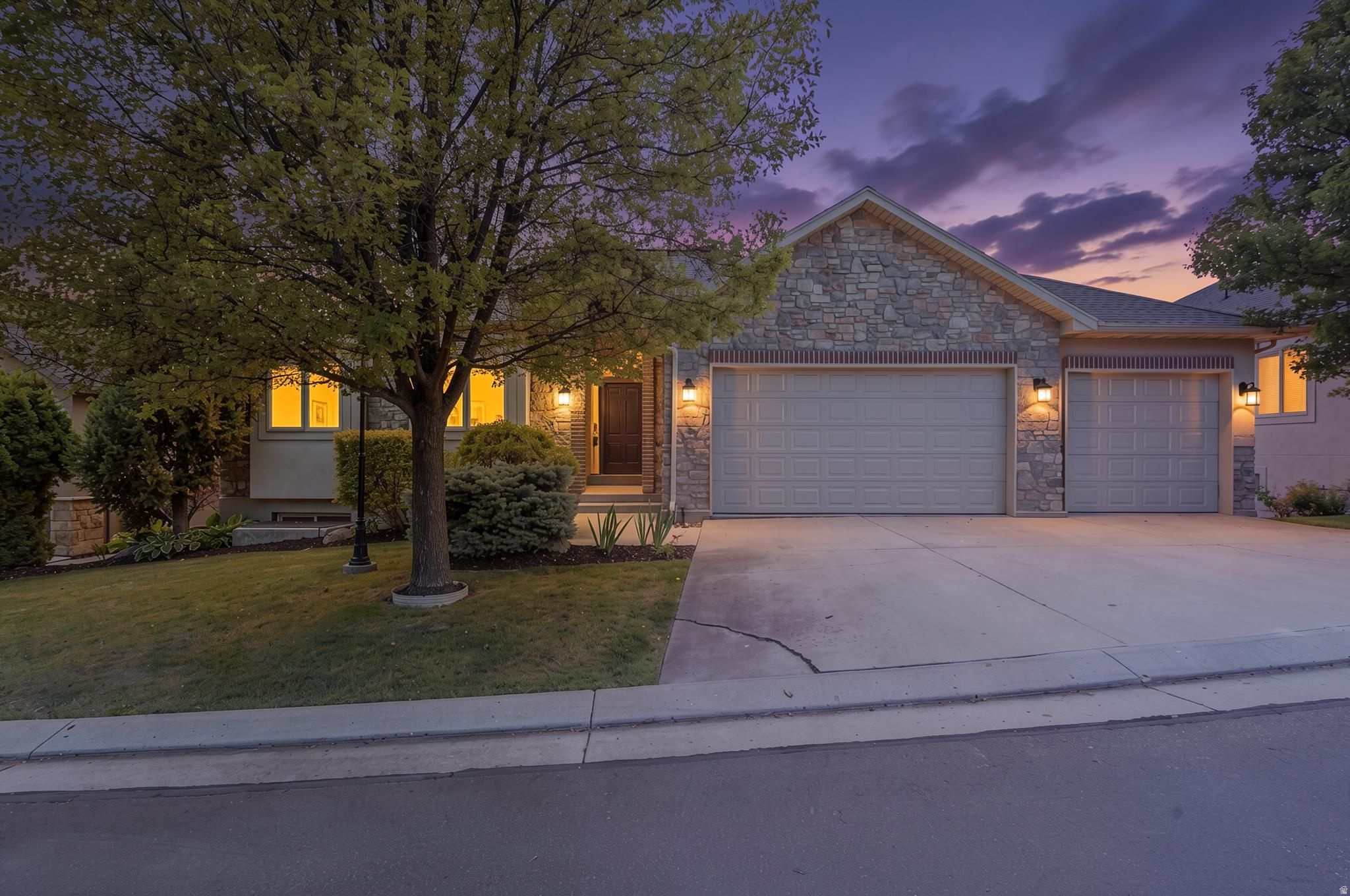 Stone and siding exterior with a two-car garage