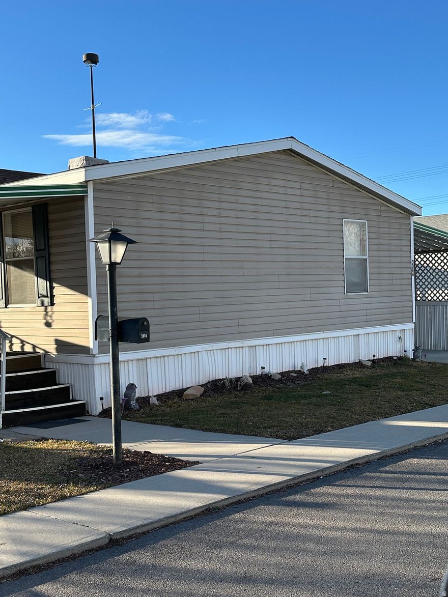 Welcome to a beautiful and inviting home located in a highly sought-after 55+ community. Enjoy relaxing on the comfortable front porch after work! This well-maintained property has been meticulously cared for over the years. This spacious open-concept home features 3 bedrooms and 2 bathrooms. The master suite is impressively large, complete with an oval tub, a separate shower, and walk-in closets with dual sinks. The vaulted ceilings add to the open feel, while the kitchen boasts an abundance of cabinets. You'll find both a formal dining room and an eat-in kitchen, along with a kitchen bar for additional seating. The layout is very open and spacious. The yard area is perfect for enjoyable barbecues, and there is a covered carport and a storage shed for your convenience. If you need assistance with financing, I can connect you with local lenders who can help you qualify for this home. This is a 55+ Over Community, Park Approval is required, please call the Park Management for Rules and Lot Rent. Square Footage provided as a Courtesy - Buyer to confirm square Footage.