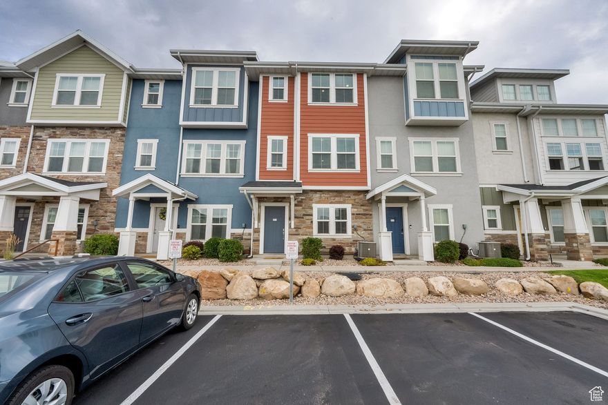 Discover this meticulously maintained 3-bedroom, 3-bath townhome in the vibrant Edgewater in Vineyard! Built in 2017, this 1,844 sq ft A-frame-style home boasts fresh carpet and bright, versatile living spaces across three levels. The open-concept second floor features a sleek modern kitchen, spacious dining area, and a large family room, perfect for entertaining or unwinding. Upstairs, find two generously sized bedrooms, including a primary suite and a secondary ensuite with a private bathroom and walk-in closet. A third bedroom and additional bathroom on the second level offer extra flexibility.  Enjoy premium features like full landscaping, central air, granite countertops, a 1-car garage, and an additional parking space (with an optional third space available). The HOA, at $275/month, provides access to a clubhouse, gym, pool, tennis courts, playground, on-site management, and more. Nestled in the top-rated Alpine School District, this home is steps from parks, shopping, dining, Top Golf, Mega Plex Theaters, and easy freeway access. Marvel at breathtaking mountain views from this prime location, adding serenity to your daily life.  Move-in ready and located in a thriving community, this townhome is your perfect opportunity to own in Vineyard!  Square footage figures are provided as courtesy estimates only and were obtained from county records. Buyer is advised to obtain an independent measurement.