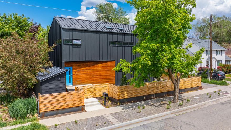 Striking modern residence in the coveted Liberty Wells neighborhood, where thoughtful design meets exceptional energy efficiency. This architecturally distinctive metal-clad home features radiant floor heating throughout and a multi-zone ductless mini-split system for optimal comfort and efficiency. The gourmet kitchen is beautifully appointed with a butler's pantry, double ovens, gas cooktop, water filtration system, and a built-in under-cabinet ice maker-ideal for refined entertaining. Floor-to-ceiling glass and a collapsible sliding door create a seamless indoor-outdoor experience, opening to a private, landscaped patio and backyard. Upstairs, the serene primary suite offers a light-filled retreat with a spacious walk-in shower and ample storage. The fully fenced, low-maintenance yard includes an electric gate and two-car carport. Situated just moments from Liberty Park, dining, and boutique shopping, this home offers elevated urban living at its finest.