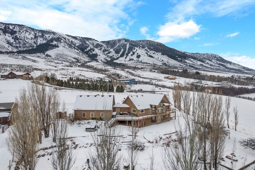 Step outside and experience true Idaho living. Ride horses, ATVs, snowmobiles, or bikes directly from the property, explore nearby National Forest access and the Boundary Trail, or unwind by the fire pit while taking in unforgettable sunsets over the mountains. Equestrian amenities include a shop, horse stalls, tack room, and corrals, making this a turn key setup for horse enthusiasts. The land itself offers exceptional future potential. Currently zoned agricultural with a second home site on the northwest corner of the property with septic, power, water, and acess easement already in place, creating added flexibility for expansion or development. With a registered spring providing water rights, stunning natural surroundings, and less than a mile to skiing, this is a rare opportunity to own a versatile mountain property that combines lifestyle, investment potential, and breathtaking views in one remarkable setting. Live Where You Play!