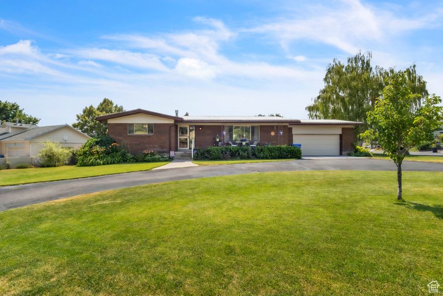Beautiful brick home with mountain views. Large living room, downstairs family room and lots of storage space. Fully remodeled kitchen with new flooring, cabinets, countertops, movable island, large pantry and new appliances. The 3 bathrooms have also been updated. This home has 2 gas fire places with new insert's. Fully landscaped yard with back deck and patio, sprinkler system, garden space, fully fenced back yard , finished 2 car garage and curved drive with ample parking. SQ FT figures are provided as a courtesy estimate only and were obtained from County records.  Buyer is advised to obtain an independent measurement.