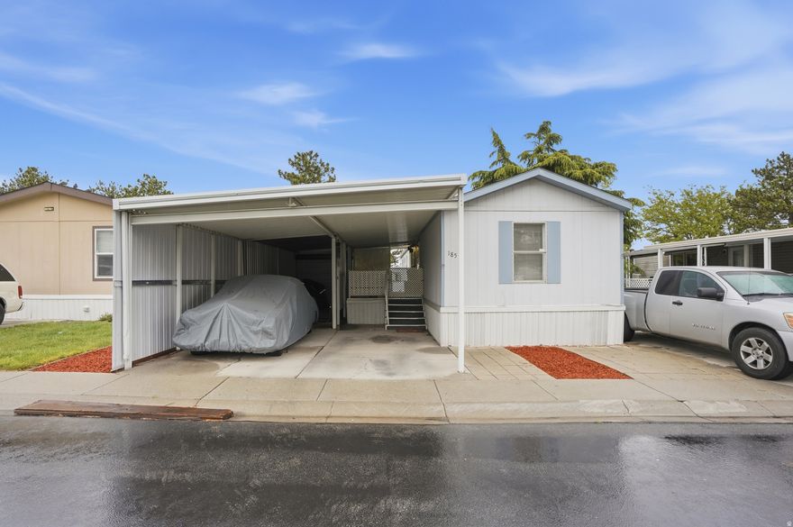 Welcome home! Take a look at this well-cared-for mobile home in Salt Lake City. It offers plenty of space, including a large family room with vaulted ceilings, two spacious bedrooms, and two bathrooms, one of which is an owner's suite. Recent updates include fresh paint, new carpet, new linoleum flooring, updated lighting, new ceiling fans, and blinds. The home has been carefully maintained, with new seals on all toilets, a Maytag furnace installed in 2024, and a roof that was updated 10 years ago. You'll also find a unique 3-car covered carport and a covered patio on the side. In the backyard, there's a large 750sq ft paver patio, a large shed, and garden boxes ready for your favorite flowers or vegetables. This home is located in the Shadow Ridge community, known as one of the cleanest mobile home parks in the valley. Contact us today for a showing! ***Please note, modular homes often need special financing since they may not qualify for conventional loans. If you need financing options, contact the agent for a lender referral.