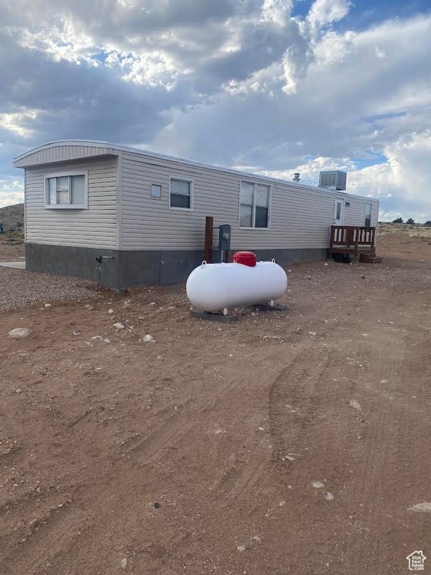 Remodeled single wide and you own the lot!  2 bedrooms, 1 bath. Front kitchen.  Brand new culinary water and sewer hook-ups. Electricity and Propane forced air furnace.  Roof mount swamp cooler. Brand new gas kitchen stove!  0.22 acre lot up on the bench for those great Utah Mountain views!  Owner/Broker