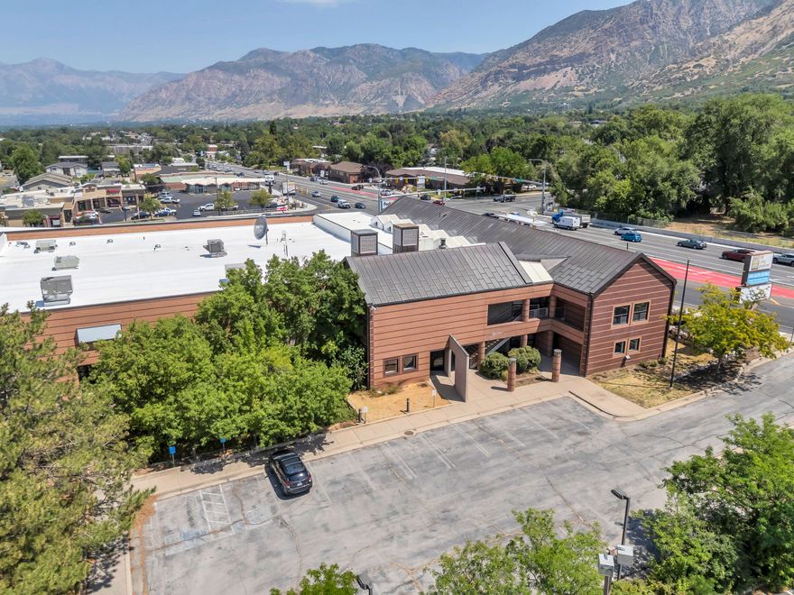High-visibility office, warehouse, and flex building in Ogden. This 51,345 SF building sits on 2.36 acres adjacent to Weber State University with frontage on Harrison Blvd., Brinker Avenue, and 37th Street, offering excellent exposure and access from US-89 and Washington Blvd. The building delivers genuine versatility: approximately 27,898 SF of professional office space across two levels, including executive offices, large conference rooms, open floor plan areas, and upper-level flex storage, plus approximately 23,447 SF of warehouse, shop, and open flex use space. Clear heights range from 10 to 22 feet. The building is equipped with heavy-duty 3-phase, 2,000-amp electrical service, four 10x14 grade-level overhead doors, one 10x12 dock-high door, a wet fire sprinkler system, elevator, and a full security and surveillance system. The 2.36-acre site provides approximately 90 on-site parking stalls, strong monument signage on Harrison Blvd., and additional street parking along Brinker Avenue and 37th Street. CP-2 (Community Commercial) zoning allows for a wide variety of office, retail, service shop, and flex commercial uses, with warehousing grandfathered as a legally permitted use. Significant remodel in 1993 and extensive interior updates completed 2023 through 2025. Ideal for an owner-user, investor, or redevelopment group. Two existing month-to-month tenants in place. Tax IDs: 05-068-0005, 05-068-0001, and 05-068-0002. Measurements provided as a courtesy only, buyer to verify all info.
