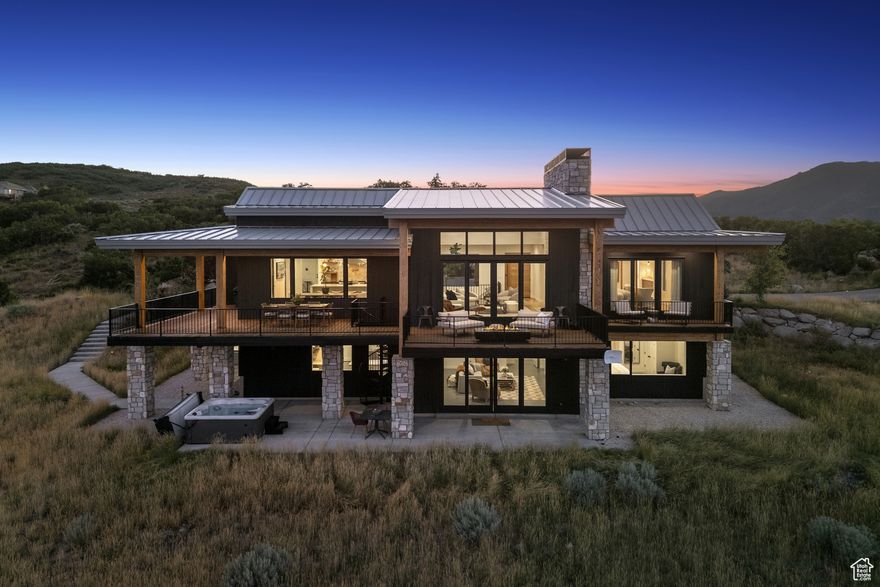 PER SELLER'S REQUEST, PLEASE CALL LISTING AGENT, NOT SELLER, FOR INFORMATION or ACCESS. A Sanctuary in the Wanship Foothills, just Minutes from Park City.  Welcome to your own private paradise in the gated community of Bridge Hollow. Perched on nearly 21 acres of breathtaking natural beauty, this exceptional 4 bedroom, 4 bath residence offers the ultimate blend of seclusion, sophistication, and soul-soothing views in every direction. Though you're just a short drive from the world-class amenities of Park City and Blue Sky Ranch, this home feels like a world apart, peaceful, private, and utterly serene. Thoughtfully designed for main-floor living, the home features a stunning Great Room and Chef's Kitchen, perfectly suited for large gatherings and quiet mornings alike. The Primary Suite is a true retreat, complete with a private deck to take in the golden light of sunrise or the stillness of star-filled nights. Generous outdoor spaces, including a sprawling deck and covered patio, invite year-round connection with the land and sky. A full lower-level kitchen and living area offer flexibility for guests or multigenerational living. An attached 2-car garage plus a separate garage/outbuilding create room for everything, whether it's a quiet office, RV storage, or your collection of cars and outdoor toys. This is more than a home, it's a place to reconnect with nature, with family, and truly soak in a slower, richer life.