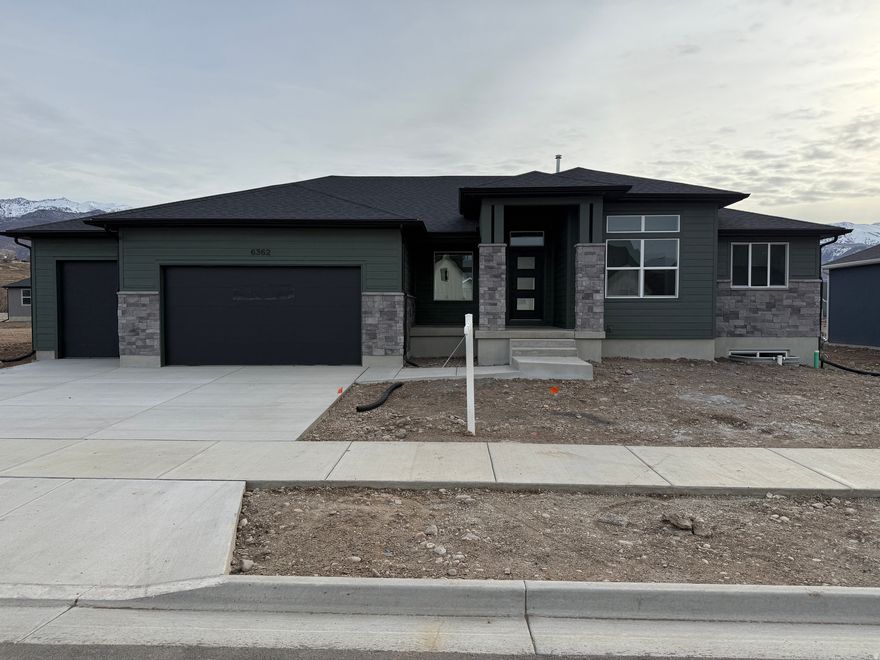 Step into this beautifully crafted rambler that truly checks every box. The modern exterior sets the tone, and inside you'll find a bright, open layout filled with natural light and elegant finishes. The main level features two spacious bedrooms that includes a relaxing primary suite, along with a large laundry room. The kitchen is a showstopper for anyone who loves to cook or entertain, with high-end appliances, stylish cabinetry, and an oversized pantry that offers incredible storage and functionality. Downstairs, the fully finished basement adds three more generously sized bedrooms, tons of storage space, and even a hidden bunker room. Car lovers and outdoor enthusiasts will appreciate the oversized 4-car garage, offering plenty of space for vehicles, tools, and toys. Sitting on a large lot with beautiful mountain views, this property gives you room to spread out while enjoying a peaceful setting. And with no HOA, you have the freedom to use your space the way you want. Located in the desirable South Weber Riverwood community, you'll enjoy the tranquility of suburban living with quick access to shopping, dining, and major routes. We're also offering some incredible incentives on this home with our prefered lenders* Be sure to ask for details. Don't miss your chance to tour this one-of-a-kind property!