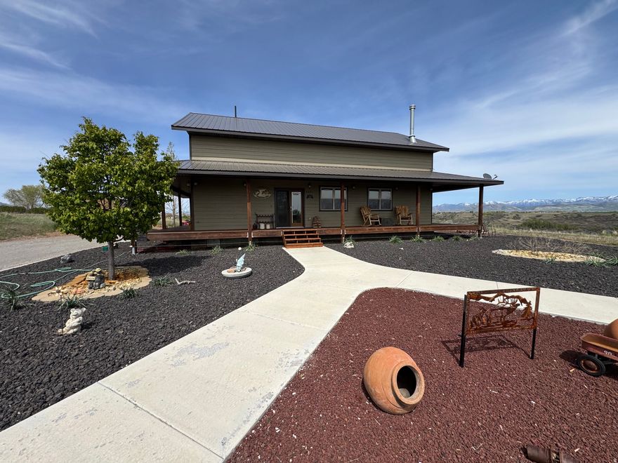 Peaceful Retreat on 2.9 Acres with Panoramic Views & Dream Shop Escape to your own private haven with breathtaking panoramic views in every direction. This home is nestled above the Bear River in Weston Idaho.  This unique property offers tranquility, abundant wildlife sightings, and stunning mountain vistas.  The quality-built home features durable smart siding, a long lasting metal roof, a cozy wood-burning stove, and the convenience of forced air heating and air conditioning for year-round comfort. Large windows fill the home with natural light while perfectly framing the surrounding landscape. The kitchen and bathrooms have newly installed upscale granite countertops. The cabinets are high end hickory wood that add to the warmth of the area. There are 2 bedrooms and 1  baths with a tiled walk in shower on the main floor. The kitchen/great room is nice sized for gathering and the upstairs bedroom loft area has a spot for sewing or other crafts.   For those needing extra workspace or storage, the fully insulated 40' x 40' shop sits on a rebar reinforced cement pad for lift, or other applications. There are power for lifts, welders, compressors etc. and oversized doors (12 ft high by 10 ft wide)-ideal for projects, vehicles, or equipment. An additional insulated Tuff Shed with power provides the perfect space for hobbies or a private workshop. The property also includes a well, an  insulated dog run with electricity for heat and fans with  both fenced outdoor space and indoor shelter. Low-maintenance xeriscaping-making this an ideal full-time residence or weekend getaway retreat. If you're looking for space, privacy, and unmatched views, this property delivers a rare opportunity to enjoy country living at its finest.