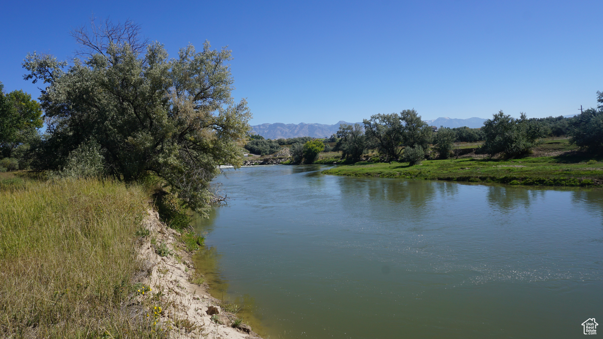 Discover the ultimate canvas for your dream recreational property on this sprawling 9.9-acre parcel. Its serene riverfront borders the Bear River on two sides of the property. The landscape is adorned by mature, wooded trees that provide a secluded and peaceful environment. Days can be spent fishing in the river, hunting in the richness of the surrounding wildlife. Or, if you prefer, it is perfect for summer livestock pasturing with access to plenty of water and feed. Whether you're looking to farm, or simply escape the hustle of city life, this property promises a future where your dreams can take root and flourish.