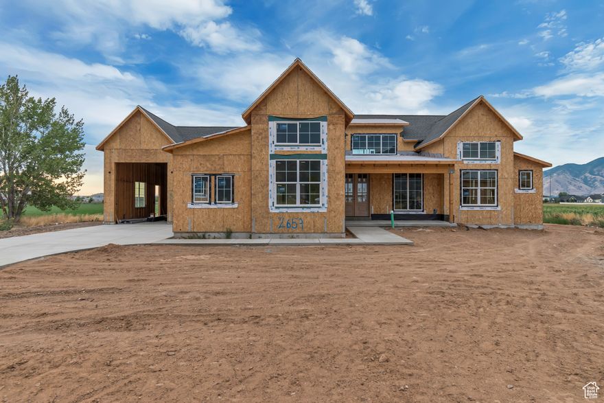 Located right on the border of Spanish Fork and Mapleton, just steps from Maple Mountain High School, this spacious and thoughtfully designed home offers incredible flexibility, comfort, and high-end features in one of South Utah County's most desirable areas. With 8 bedrooms, 5 bathrooms, and 5,185 square feet of living space, there's room for everyone. The main level features 4 bedrooms, including a luxurious master suite and a guest en-suite, plus a dedicated office/den right off the entry. The home sits on a large 0.35-acre lot with a south-facing driveway that provides great natural light and quick snow melt in the winter. Oversized sliding glass doors frame beautiful mountain views and open to a spacious backyard, perfect for entertaining, relaxing, or adding future amenities. Inside, you'll find two full kitchens, two laundry rooms, and three large family rooms, making the layout ideal for multi-generational living or rental income. The basement includes a fully finished apartment (ADU) with a private entrance and its own parking pad. It was carefully designed so the main residents still retain access to cold storage, two bedrooms, a full bathroom, and a private family room. With RC channeling in the ceiling and separate HVAC zones, the basement apartment is quiet, private, and truly feels like its own space. The oversized RV garage adds even more value and functionality, providing storage for all your vehicles and toys. This home checks every box-space, location, and thoughtful design all in one. Estimated completion is beginning of November.