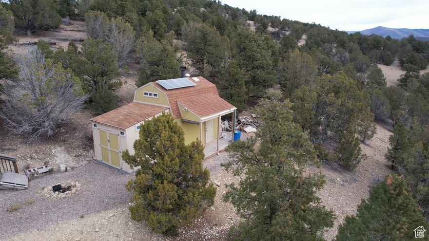 Location! Location! Location! No HOA and completely off grid! Reduced price for quick sale and includes a recently "proofed" .75 acre foot water right #51-8943 which is 'Grandfathered' to be enough to drill a well since the subdivision was established before April 2004 (per conversation with Tim at Sanpete County Zoning). This could be your very own private bugout/strategic property which includes two attached Tough Sheds making a delightful 292 sq ft bunkhouse with a loft which sleeps up to 5, a wood stove, solar panels, two batteries, a small fridge, small high windows (to protect against break-ins) in every room, skylight, some insulation, a 5'x12' covered deck faces east to capture glorious sunrises and enjoy the mountain and valley views. Until you drill the well, a 55-gallon water barrel serves as the receptacle for drinking water. About 150 feet from the bunkhouse is a basic outhouse which uses two partially buried 55-gallon drums with the bottoms cut out to process waste like a septic system. For your comfort, a regular toilet 'seat' sits on top of the wooden platform which rests above the barrels. A 20' clothesline/dogrun runs from the bunkhouse to a tree with a cord (to attach to your dogs collar) to keep him/her close and not allow her/him to run off chasing after who-knows-what! Mostly Year-Round, you'll need four-wheel drive or possibly a vehicle with tracks during heavy snow fall. This incredible property comes with all the amenities Sanpete has to offer: grocery and hardware store, restaurants, drive-in movie theater, hospital, aquatics center, and miles of trails for your four-wheeler, side-by-side, snow shoes, hiking, or mountain bikes. This is a wonderful place to enjoy making memories (and S'mores) over the firepit, telling stories, hiking or riding, and looking at the stars! Come to Sanpete - you'll love it here! Arrange an appointment today to see this 'Hidden Gem'!