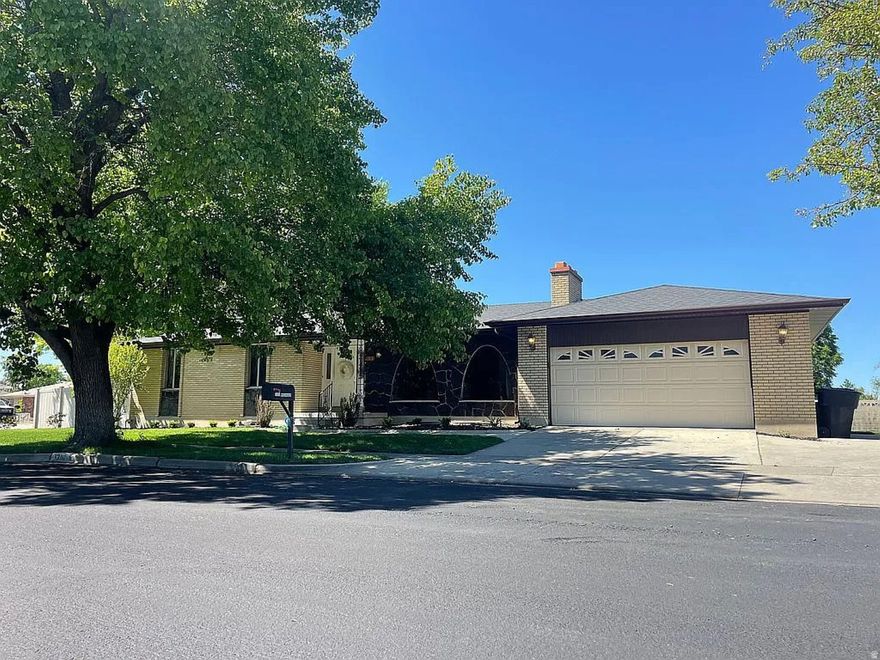 Welcome home to one of the best locations in the neighborhood! Tucked away on the very last street, this home offers peace, privacy, and minimal traffic in an established community lined with mature trees. Situated on a spacious .29-acre corner lot, there's plenty of room to enjoy the outdoors, entertain, play, or park your trailer, boat, or toys with the oversized side driveway.  Inside, the home is filled with natural light thanks to large windows throughout and features thoughtful updates that make it both stylish and functional. The fully updated kitchen includes granite countertops, updated flooring, a pantry, and a gas range perfect for cooking and gathering. The inviting layout offers great flow for everyday living with multiple gathering spaces and two cozy fireplaces.  The spacious primary suite is conveniently located on the main level and easily accommodates a king-size bed, creating a comfortable private retreat. The updated primary shower adds a fresh, modern feel to the space. Upstairs, you'll find two additional bedrooms, while the downstairs offers a guest room and dedicated office space, giving flexibility for visitors, working from home, hobbies, or a growing household.  With updated features, beautiful natural light, established trees, and space to grow both inside and out, this home combines comfort, functionality, and charm in a truly hard-to-beat location.   And say goodbye to long commutes and enjoy the perfect balance of convenience and comfort. Located just 6 minutes from the freeway, less than 20 minutes from downtown Salt Lake City, and only 15 minutes from the airport, this home makes getting anywhere in the valley quick and easy while still offering the peace and quiet of an established neighborhood.