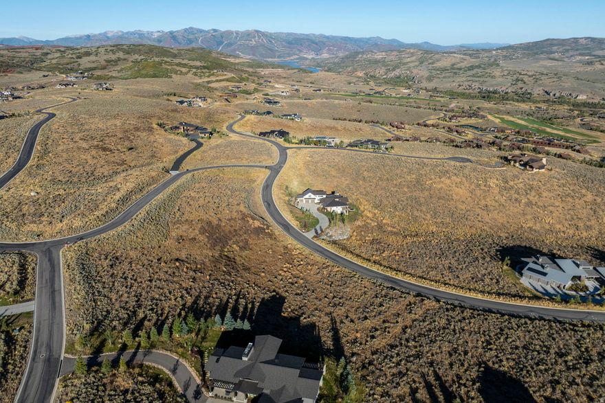 Set against sweeping mountain vistas, this 3.6-acre Estate Lot captures the essence of mountain living at Victory Ranch. The elevation of this lot provides long view corridors in several directions including a panoramic sweeping view of Deer Valley, the Rees Jones golf course, Flat-Top mountain, the Rock Cliffs, and the Unita Mountain range.  This gently sloping downhill lot allows for a large home up to 9,000 sq ft, blending architectural freedom with an easy build site. Located just a short stroll from The Barn amenity, the VR activity hub with spa, pool, fitness,  game room, sport court, Parlor restaurant, tennis, pickle and paddle courts.   Surrounded by beautifully constructed homes, this corner lot provides a balance of privacy and community. The 20,795 sq ft building pad, complete with sun study, and fully stubbed utilities make this an architect-ready site.  This lot also offers view permanence with open space below and adjacent lots already built. This is the ideal opportunity to create your own serene retreat or statement mountain estate.  Nestled on 6,250 acres with four miles of private frontage on the Upper Provo River, Victory Ranch is a premier four-season private community offering world-class recreation and refined mountain living. Highlights include an 18-hole Rees Jones golf course, fly fishing, upland bird hunting, and 30+ miles of trails for hiking, biking, and exploration across 3,500 acres of backcountry. Amenities include The Post Clubhouse with concierge services, pool, hot tubs, and caf; and The Barn, featuring a fitness center, spa, sport courts, pool, water slide, and family recreation spaces. Additional offerings include a shooting facility, archery range, ATV and snowmobile trails, backcountry yurts, restaurants, private ski lodge in Park City, and shuttles to Deer Valley & Park City. Ideally located 15 minutes from Deer Valley, 25 minutes from Park City, and under an hour from Salt Lake City International Airport, Victory Ranch combines adventure, community, and luxury in one exceptional setting.