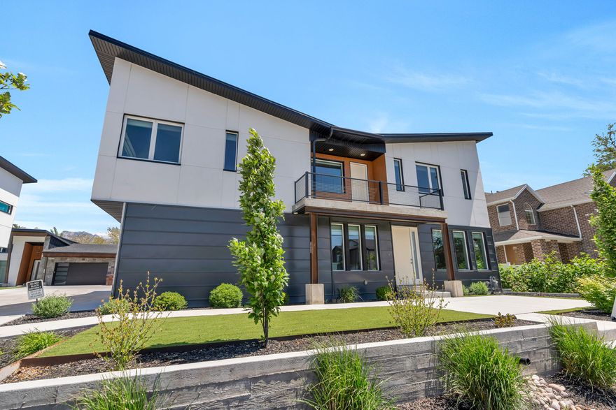 Striking modern twin home in Midvale built with concrete construction, offering exceptional durability, sound separation, and energy efficiency that sets it apart from anything else in the area. The main level features polished concrete floors, a spacious living area filled with natural light, and a well-appointed kitchen with white cabinetry, a large island, and a gas range. Upstairs, the primary bedroom includes a walk-in closet and a private ensuite, and two additional bedrooms share a full bathroom. A generous living area on the upper level provides additional space for relaxing or entertaining, along with a convenient laundry room. The fully finished basement offers 9-foot ceilings, a large recreation room, and a half bathroom. Additional highlights include a covered balcony with mountain views, a low-maintenance lot, and a 2-car garage. Conveniently located near shopping, dining, and major commuter routes in a desirable Midvale location. Measurements provided as a courtesy only, buyer to verify all info.