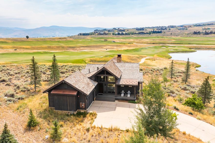 Nestled along the first fairway of Victory Ranch's premier golf course, this stunning 3-bedroom Willow Cabin Home offers sweeping views of the course, ponds, and the majestic Uinta Mountains. Thoughtfully designed for comfort and style, the home features a spacious open-concept layout with an inviting kitchen, a generous breakfast bar perfect for gathering, and a great room with vaulted ceilings, reclaimed barnwood wrapped fireplace, and expansive windows to take in the breathtaking scenery. Main level offers a King en-suite that opens to the deck. The lower-level family room provides a second space for relaxing or entertaining, a king suite and a bunk suite. Custom-built bunk beds add a charming, functional touch for guests or kids. All three bedrooms offer ensuite bathrooms. Whether you're enjoying quiet mornings on the deck or cozy evenings by the fire, this Willow Cabin is the perfect four-season mountain escape. Walk to the new Golf Clubhouse! Victory Ranch is a private, four-season community amidst 6,250 pristine acres along four miles of the Upper Provo River. Amenities include an 18-hole Rees Jones golf course, world-class fly fishing, upland bird hunting, 30+ miles of mountain biking and hiking trails, 5-stand shooting facility, archery range, 4x4 adventures, snowmobiles, kids zip-line, backcountry yurts, fishing ponds, multiple restaurants, shuttles to Deer Valley & Park City, a ski-in/ski-out lodge in Park City, and more than 3,500 acres of untouched backcountry. The Post Clubhouse includes our concierge team, heated pool, hot tubs, lounge, and coffee/ice cream bar. The Barn features a fitness center, spa, general store, pizza and ice cream parlor, art studio, game room, indoor basketball/sport court, tennis, paddle, and pickle courts, swimming pool with food and beverage service, water slide, event lawn and will be sure to provide hours of family fun. Victory Ranch is less than an hour from Salt Lake airport, approximately 15 minutes from Deer Valley and 25 minutes from Park City.