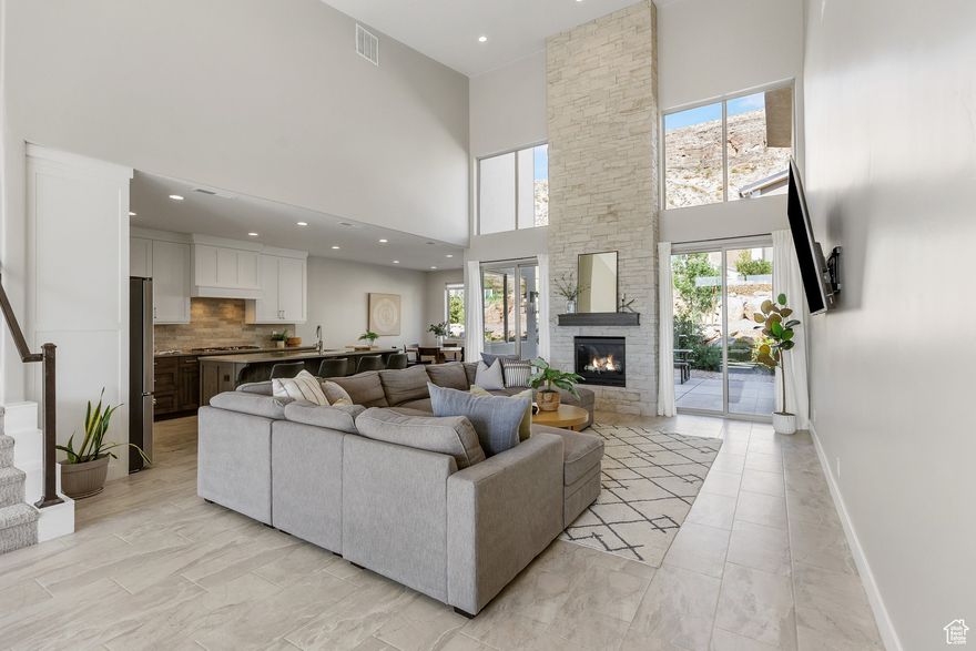 Perched in a brand-new subdivision with sweeping views of Pine Valley, this spacious, modern home blends style, comfort, and functionality. Thoughtfully designed with full landscaping, rock retaining walls, and an elevated setting, it offers a true "wow" factor from the curb to the upper-level deck. Inside, the kitchen shines with floor-to-ceiling soft-close cabinets, quartz countertops, porcelain tile backsplash, walk-in pantry, and high-end GE Profile appliances-including a WiFi-enabled oven, GE fridge, and Whirlpool dishwasher. Nine-foot ceilings, a pullout double garbage bin, central vacuum and smart storage add to the convenience. The living room boasts 19-foot vaulted ceilings, a stone gas fireplace that stretches to the ceiling, and dual 8-foot sliding doors that fill the space with light. Upstairs, a 24'x8' covered deck offers an incredible perch to take in Pine Valley's beauty. The primary suite includes a sliding glass door to the backyard, a soaking tub, walk in closet and walk in shower. The entry has transom windows and a cozy sitting area with a built-in window seat, while the 8-foot front door with privacy glass and a Schlage keypad lock sets a modern tone. All closets include built-in shelving, blinds are installed throughout, and the oversized 3-car garage offers extra-tall 11 foot four inch ceilings for maximum storage. An owner's closet with a locked door adds flexibility for part-time or rental use. With its prime location close to Zion and unmatched views, this home is ready to impress. The home is a short drive to the sheer massive cliff walls of Zion National Park, the hoodoos of Bryce Canyon National park, or the North Rim of The Grand Canyon. There is no place like it. Enjoy nearby hiking, biking, and outdoor adventures or any of the 4 amazing large reservoirs and thousands of recreational public acres for the adventurous at heart. The region is also known for its internationally renowned golf courses that recently hosted the PGA tournament and will soon host the LPGA. Saint George is also the host for many events such as the Ironman, Red Bull Rampage, and the Saint George Marathon.All information herein is deemed reliable but is not guaranteed. The buyer is responsible to verify all listing information, including square feet/acreage, to the buyer's own satisfaction.