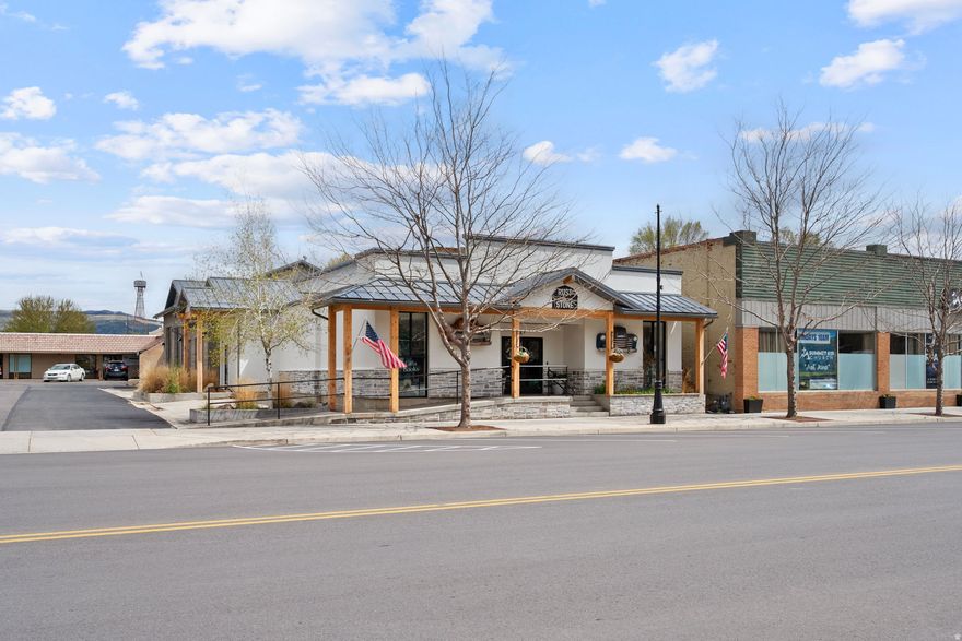 Prime commercial property on historic Main Street in Coalville offering 5,572 sq ft total-2,196 sq ft of finished office/retail space plus 3,376 sq ft of shop space.  Front area features an industrial prep kitchen with freezer/refrigerator units, dual sinks, oven/cooktop, ample storage, bathroom, and break room-ideal for food service, retail, or office use. ADA access to Main Street and ample parking. The kitchen equipment is not included in the sale but can be purchased separately.  Shop area includes 2 10 feet and 2 14 feet rolling steel doors, providing excellent access for contractors, light industrial, warehouse, or service uses.  High-visibility location in Coalville's growing business district. Excellent opportunity for owner-users or investors seeking flexible commercial space.