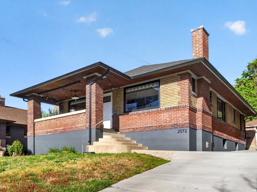 Stained glass and large front windows welcome you into this 1923 Ogden East Bench home, where natural light and character define the space. The 2,238 sq ft layout offers 4 bedrooms and 2 bathrooms, with beautiful wood trim in all the right places, a wood-burning fireplace, formal dining, original built-ins with a classic ironing board closet and a breakfast nook with vintage character. The kitchen is updated with granite countertops, white cabinetry, backsplash, disposal, and dishwasher. The lower level includes two of the four bedrooms, a bathroom, laundry, and an additional living space for flexible use. Smart improvements include a new main sewer and water line, complete plumbing replacement, tankless water heater, whole-house water filtration system with water softener, replaced AC compressor, newer roof and gutters, new windows, updated electrical panel, added electrical to the garage, a new concrete driveway with a drainage channel, along with a full backyard renovation. Out back, the yard is private and set up for outdoor living with xeriscaping, an extended patio, string lighting, propane fire pit, a new hot tub, and privacy fencing, all oriented toward east bench views and evening ambiance. Extra-long concrete driveway and a 1-car garage provide parking and storage. Conveniently located near the local favorite, Kaffe Merc and nearby trailheads. Furnishings are available for purchase.