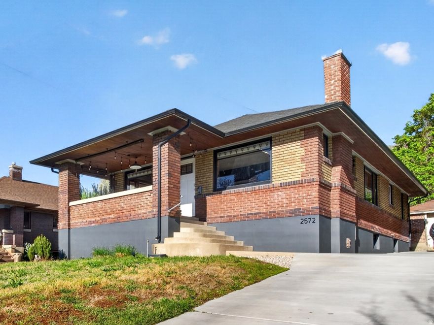 Stained glass and large front windows welcome you into this 1923 Ogden East Bench home, where natural light and character define the space. The 2,238 sq ft layout offers 4 bedrooms and 2 bathrooms, with beautiful wood trim in all the right places, a wood-burning fireplace, formal dining, original built-ins with a classic ironing board closet and a breakfast nook with vintage character. The kitchen is updated with granite countertops, white cabinetry, backsplash, disposal, and dishwasher. The lower level includes two of the four bedrooms, a bathroom, laundry, and an additional living space for flexible use. Smart improvements include a new main sewer and water line, complete plumbing replacement, tankless water heater, whole-house water filtration system with water softener, replaced AC compressor, newer roof and gutters, new windows, updated electrical panel, added electrical to the garage, a new concrete driveway with a drainage channel, along with a full backyard renovation. Out back, the yard is private and set up for outdoor living with xeriscaping, an extended patio, string lighting, propane fire pit, a new hot tub, and privacy fencing, all oriented toward east bench views and evening ambiance. Extra-long concrete driveway and a 1-car garage provide parking and storage. Conveniently located near the local favorite, Kaffe Merc and nearby trailheads. Furnishings are available for purchase.