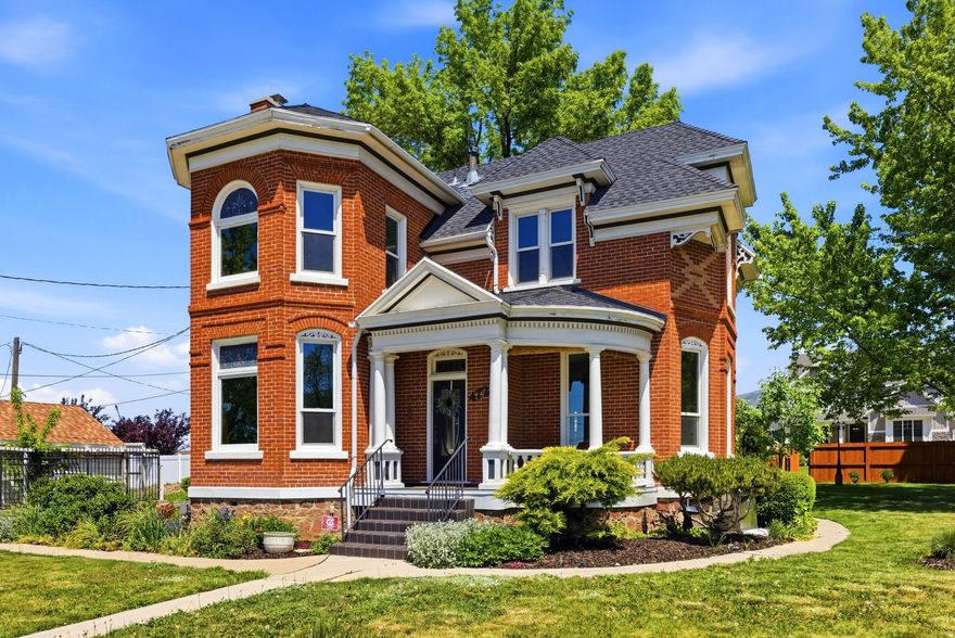 Built circa 1900 this historic home is a rare piece of living history in the heart of Kaysville. Designed by celebrated Davis County architect William Robert Allen - the same craftsman behind the Kaysville Tabernacle and Barnes Bank Building - this Victorian Eclectic brick residence commands attention with its central-block-projecting-bays design, ornate exterior detailing, and five stained glass window features. Inside, 10-foot ceilings on the main, a true parlor, push-button electrical switches (updated electrical though), two fireplaces with tiger wood, Venetian plaster up the staircase, and period lighting with ornate ceiling medallions speak to a level of craftsmanship that simply isn't built anymore. In true Victorian fashion, the kitchen lives in two intentional spaces - a butler's pantry with period sink leads into a separate cooking room anchored by a Majestic wood-burning stove converted to natural gas, preserving the rhythm of how this home was meant to be lived in.  The outdoor park like yard features an outdoor stone fireplace with patio, and a young orchard with 7 fruit trees complete this one-of-a-kind property.  Modern updates: roof 2021. Anderson windows 2025, dual furnaces & ACs, brand new water heater, updated electrical, new bathroom 2023.